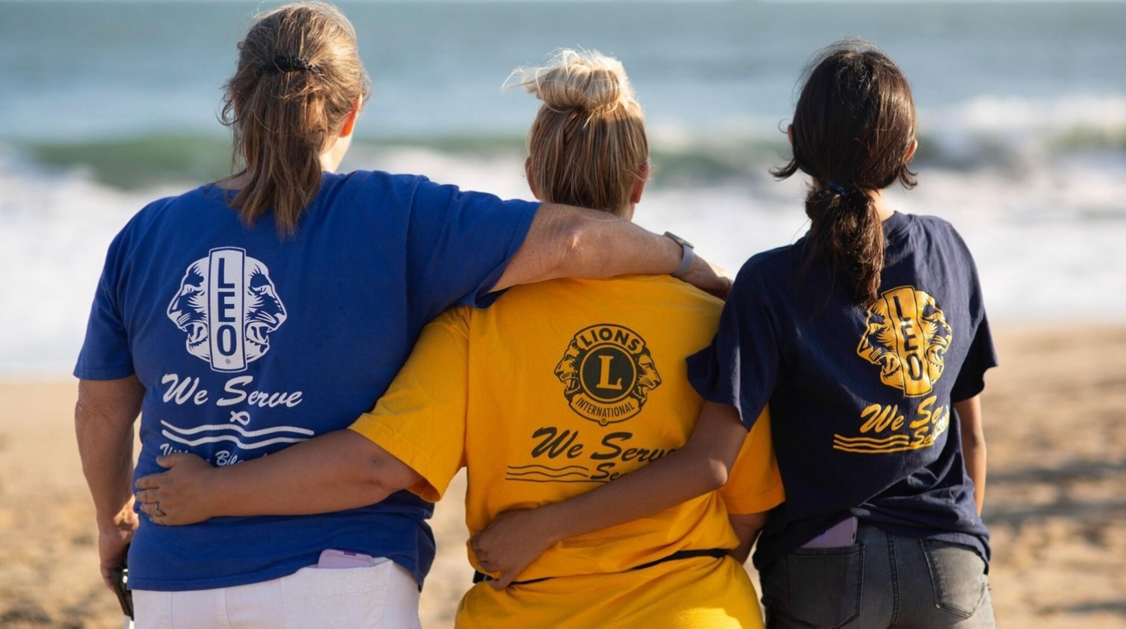 Picture of three Lions Club members looking at the ocean